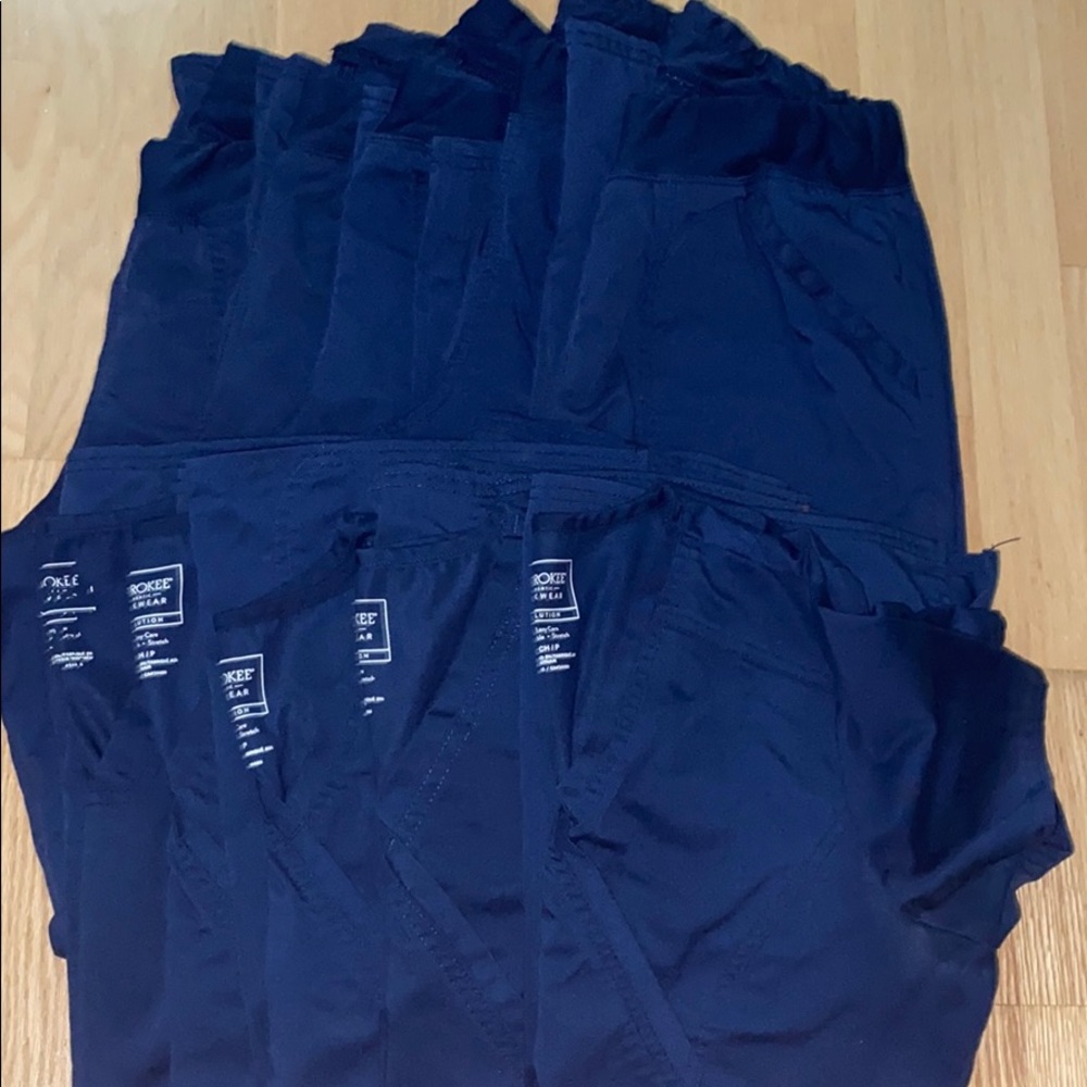 Multiple (5 each) navy scrub bottoms and tops.